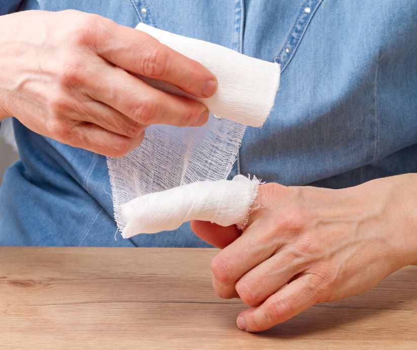 Woman bandaging her finger.